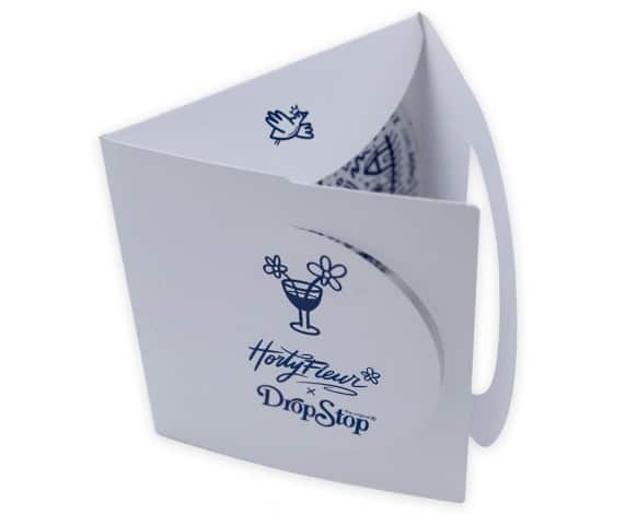White product packaging or tote with a blue cocktail-glass-and-flower logo and the text 'Drop Stop' on the front.